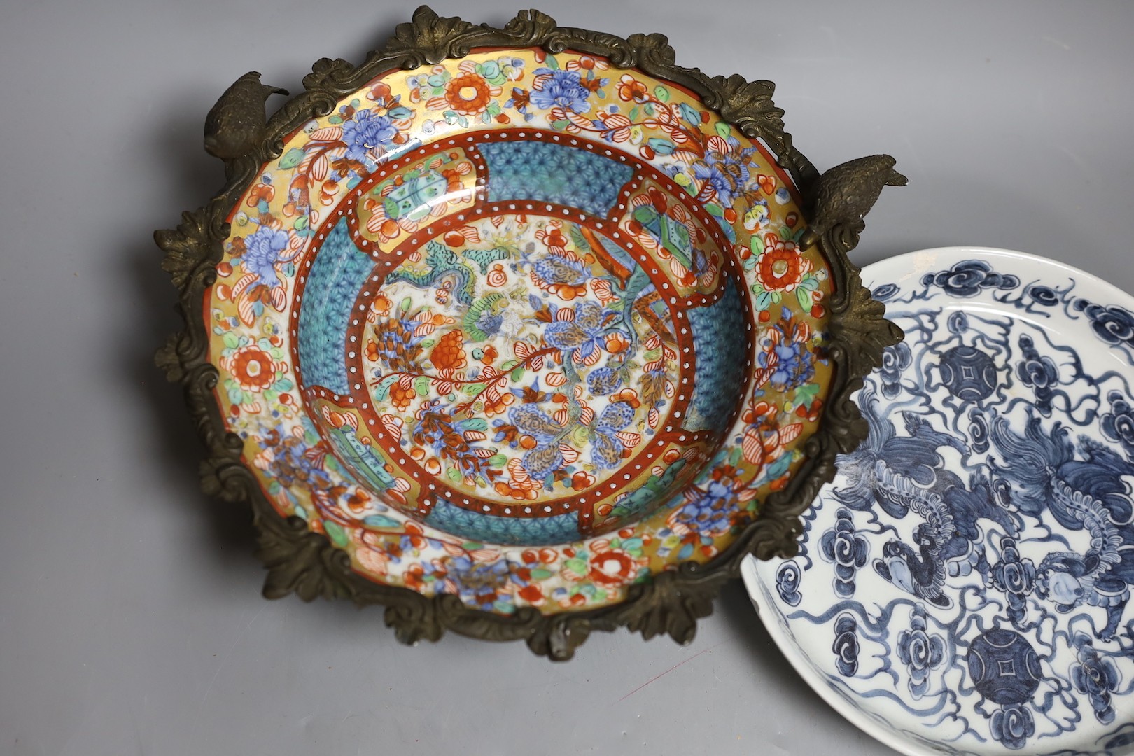 A Chinese clobbered dish with bronze mount, a Chinese blue-and-white Buddhist lion dish and a blue and white landscape bowl, 18th century and later